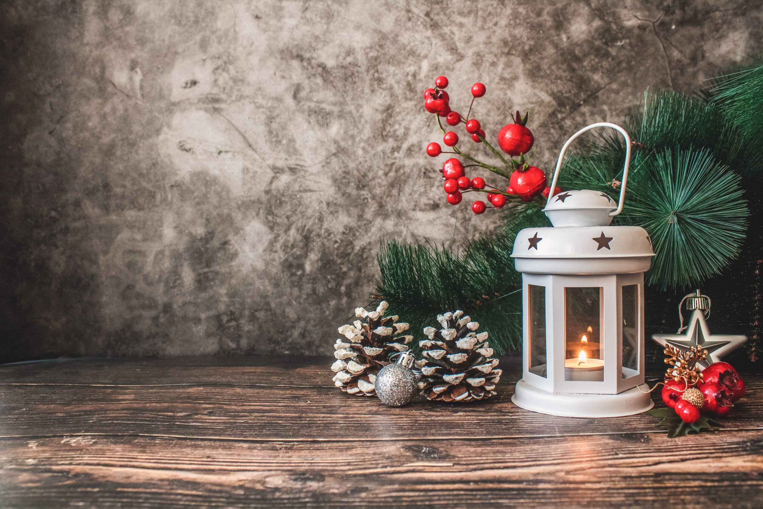 Christmas scene with lantern and pinecones